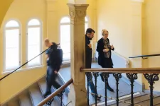  Three persons walking in stairs at the Pufendorf IAS. Foto